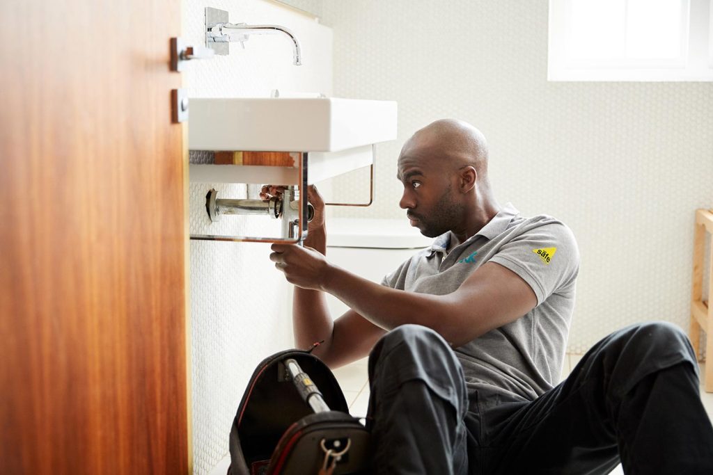 man repairing a sink